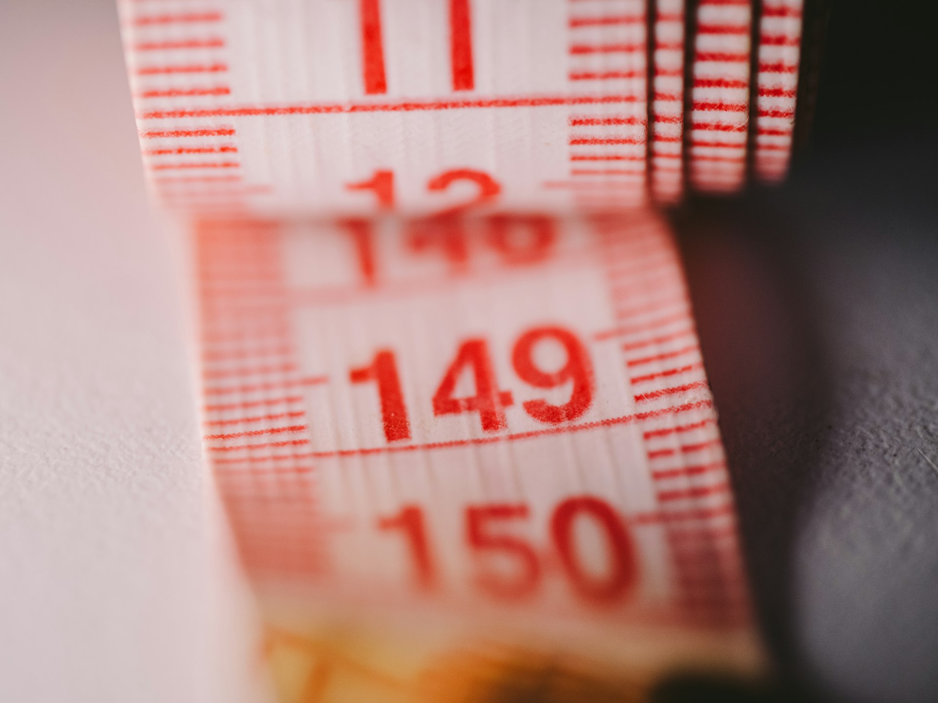 A red measuring tape shows a number.